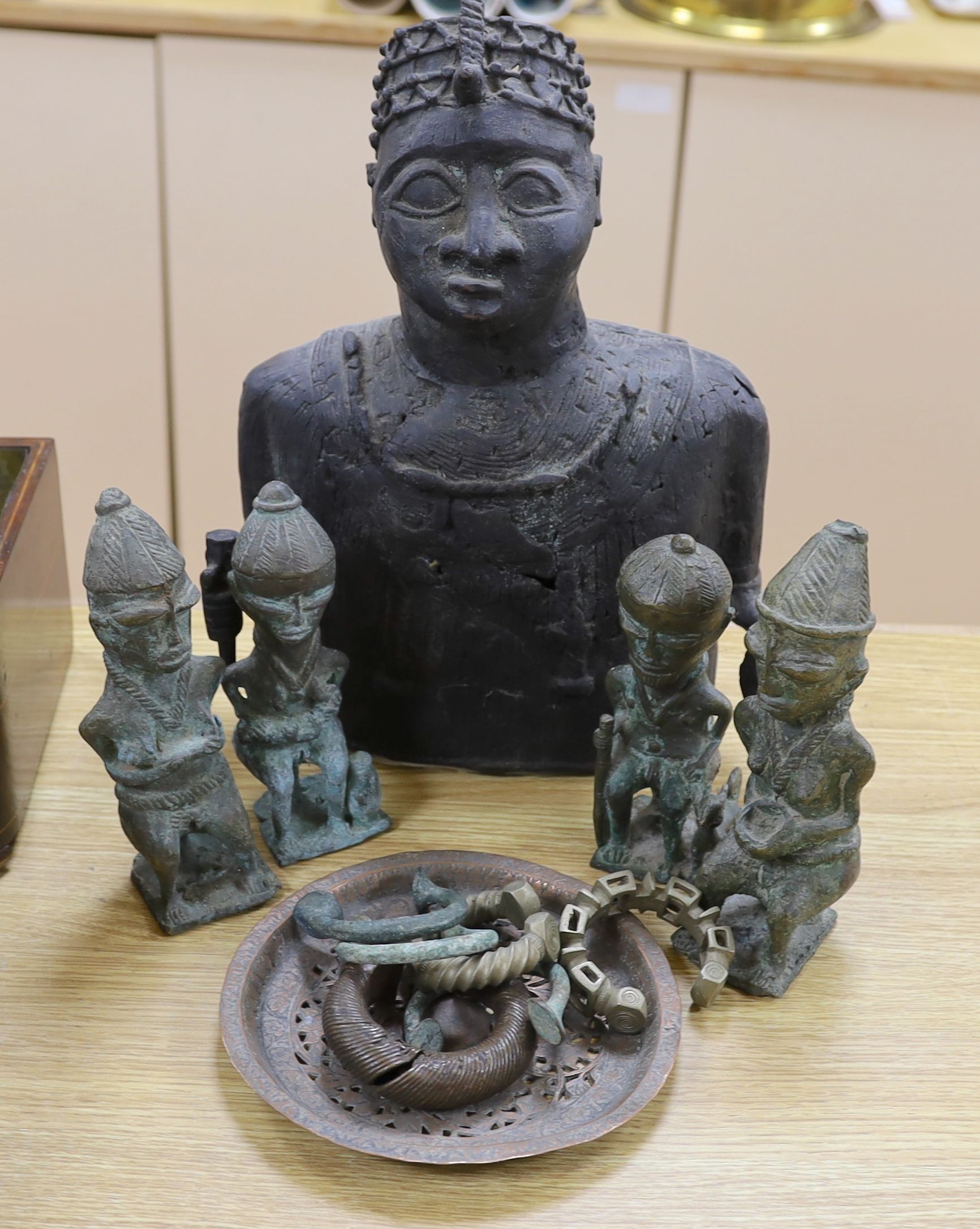 A group of Nigerian cast metal figures, bangles and a dish, tallest 36 cms high.